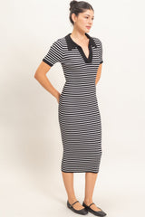 woman wearing a black and white striped short sleeve midi dress with a v-neck and black collar