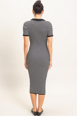woman wearing a black and white striped midi dress with a fitted silhouette and short sleeves, seen from the back