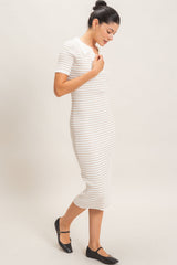 woman wearing a cream and tan striped short sleeve midi dress with a collared neckline and black flats