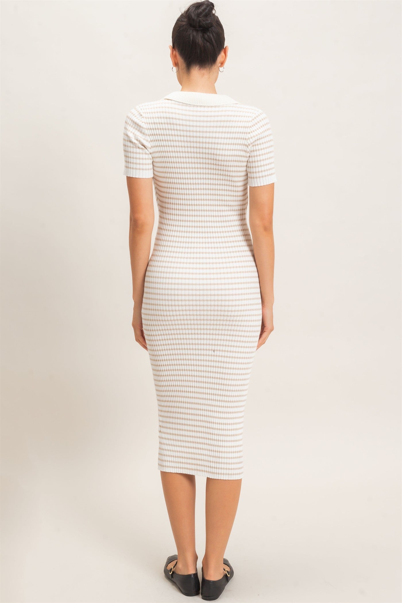woman wearing a fitted cream and beige checkered midi dress with short sleeves, viewed from the back