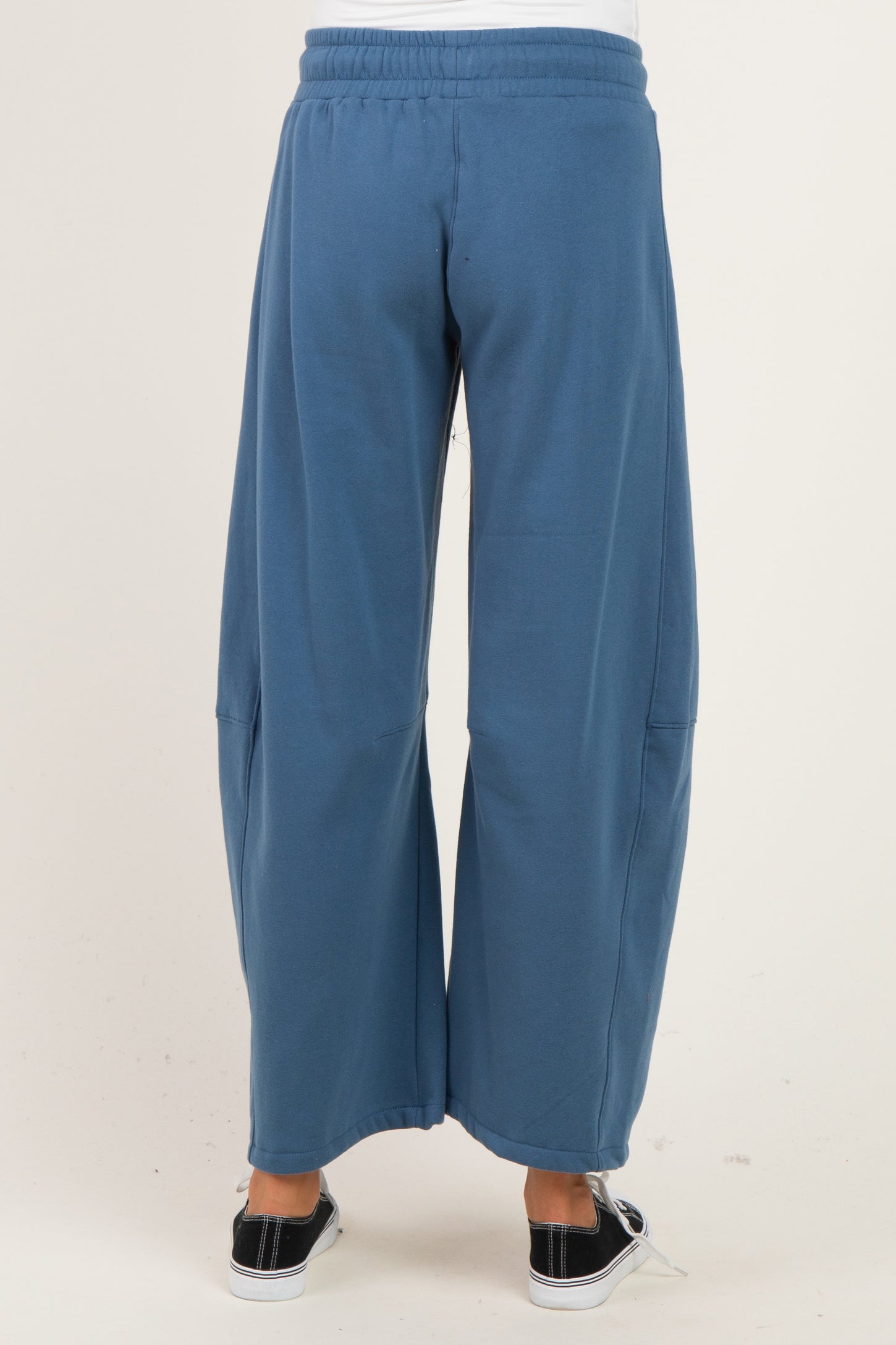 woman wearing blue wide-leg maternity sweatpants, shown from the back