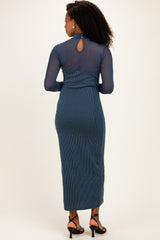 woman wearing a long sleeve blue ribbed maxi dress with a keyhole back and fitted silhouette