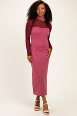 woman wearing a burgundy long sleeve midi dress with sheer top and ribbed texture, standing with one hand on her hip