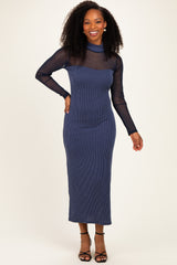 woman wearing a navy striped long sleeve midi dress with a sheer neckline and black strappy heels