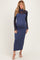 woman wearing a navy blue ribbed maternity dress with long sheer sleeves and a visible baby bump