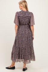 woman wearing a floral print maternity maxi dress with short flutter sleeves and a smocked waist, viewed from the back