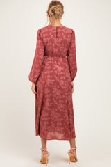 woman wearing a rust floral long sleeve maternity dress with a flowing silhouette and back button detail