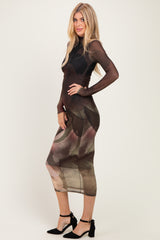 woman wearing a long sleeve sheer midi dress with floral print and fitted silhouette, styled with black ankle strap heels