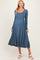 woman wearing a blue long sleeve maternity dress with a scoop neckline and flowing skirt, showing a baby bump
