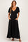woman wearing a black maxi dress with short sleeves, v-neckline, and pockets
