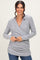 woman wearing a gray ribbed wrap top with long sleeves and a relaxed fit, smiling at the camera
