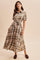woman wearing a brown and cream plaid button-down maxi dress with a tie waist and short sleeves