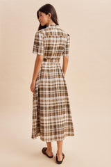 woman wearing a brown and white plaid midi dress with a belted waist and short sleeves, seen from the back