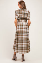 woman wearing a brown and white plaid maternity dress with short sleeves and a tied waist, showing off her baby bump from behind