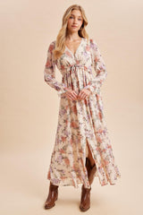 woman wearing a floral maxi dress with long sleeves and a tie waist, paired with brown ankle boots
