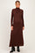 woman wearing a brown ribbed turtleneck maternity dress with long sleeves and a flowing silhouette