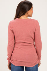 woman wearing a dusty rose long sleeve maternity top with gathered sides, showing a smooth back view