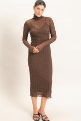 woman wearing a brown sheer long sleeve midi dress with a turtleneck and textured design