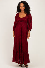 woman wearing a burgundy long sleeve lace maxi dress with a square neckline and ruffle hem