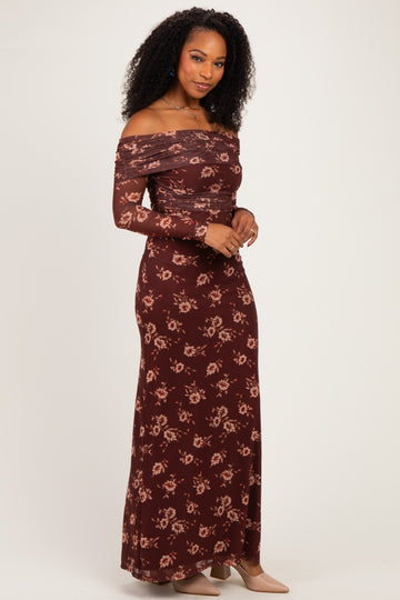 woman wearing a burgundy off-the-shoulder maxi dress with floral print and long sleeves