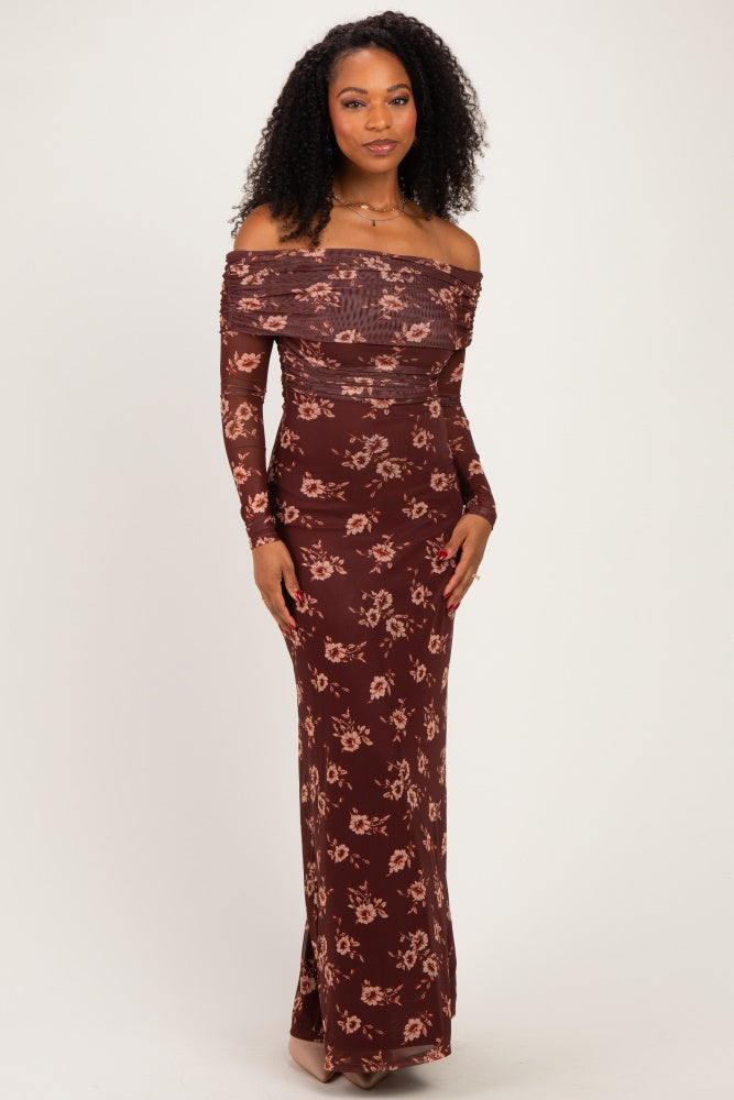 woman wearing a burgundy off-the-shoulder floral maxi dress with long sleeves and a fitted silhouette