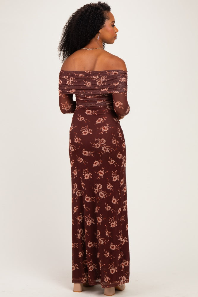 woman wearing a burgundy off-the-shoulder maxi dress with a floral print, viewed from the back