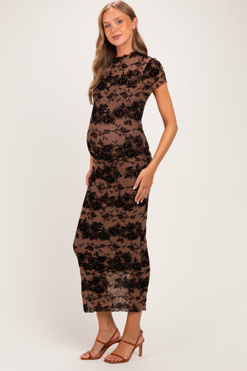 woman wearing a brown floral lace maternity dress with short sleeves and a visible baby bump
