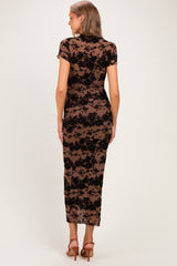 woman wearing a black lace maternity dress with short sleeves and a fitted silhouette, showing a smooth silhouette from the back