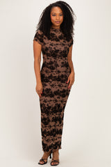 woman wearing a form-fitting brown floral lace gown with short sleeves and a sheer overlay