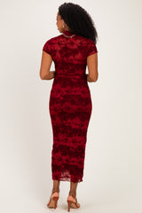 woman wearing a fitted burgundy lace dress with short sleeves and a midi length, showing the back view