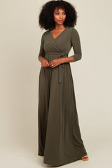 woman wearing an olive green long sleeve wrap maxi dress with a tied waist detail