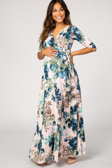 woman wearing a floral wrap maternity dress with three-quarter sleeves and a visible baby bump
