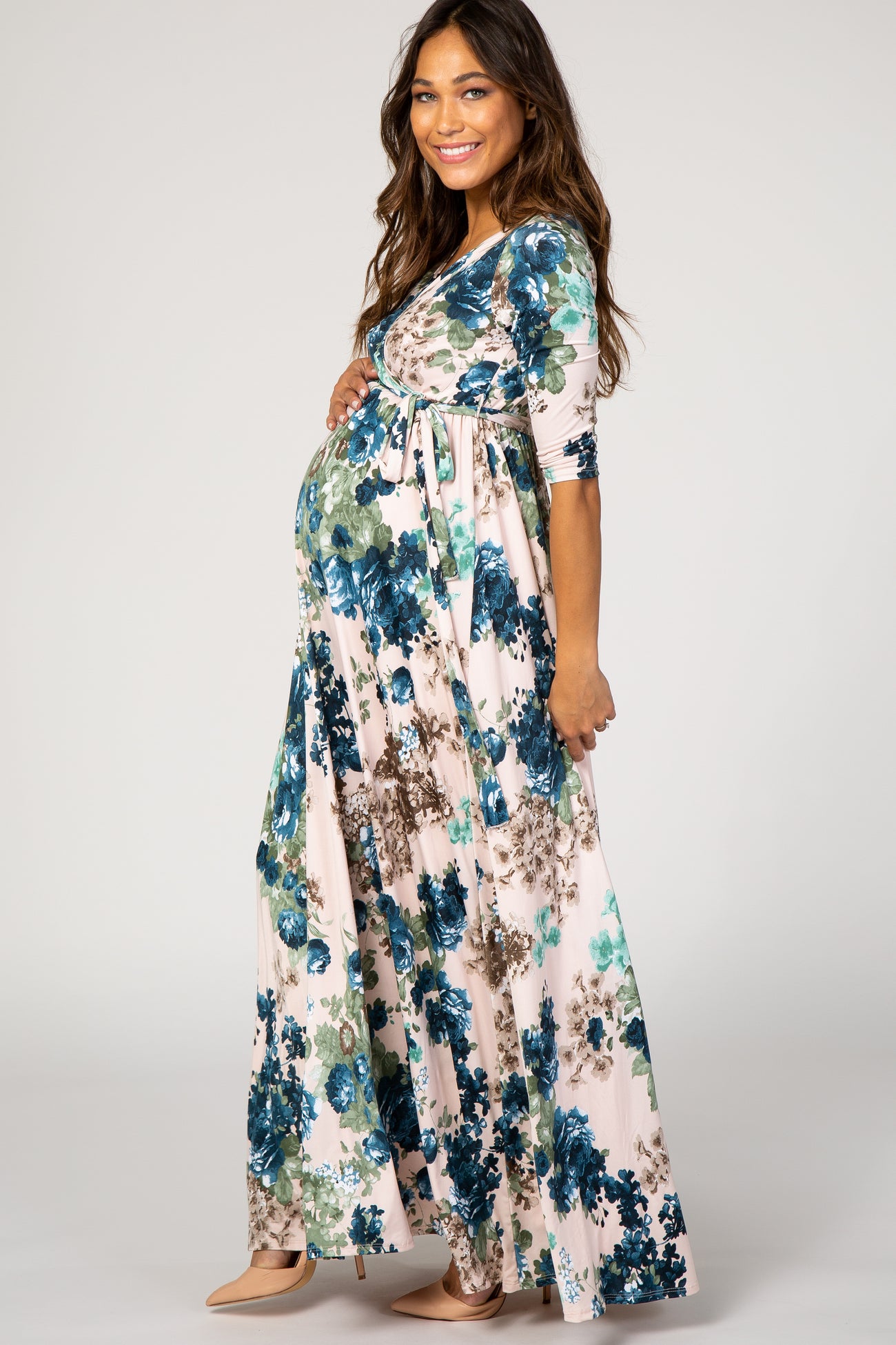 woman wearing a floral print maternity maxi dress with short sleeves and a baby bump visible