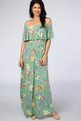 woman wearing a light green off-the-shoulder maxi dress with floral print and ruffle detailing
