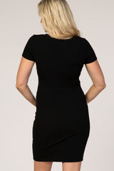 woman wearing a black short sleeve ribbed maternity dress, showing the back view
