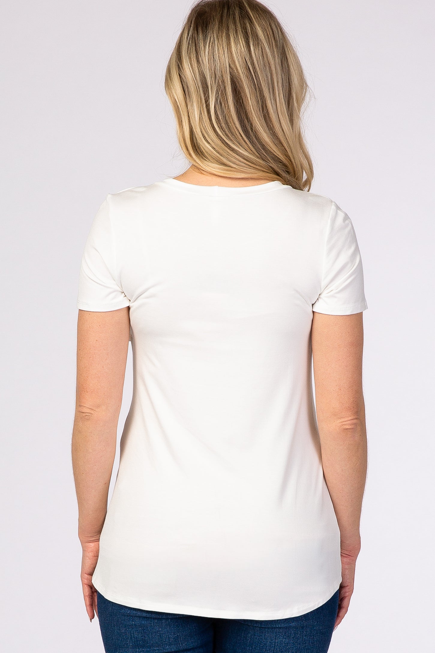 woman wearing a white short sleeve maternity top viewed from the back