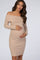 woman wearing a beige off-the-shoulder ribbed maternity dress and holding her baby bump