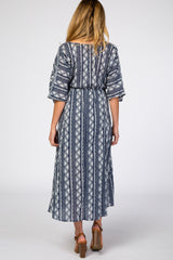 woman wearing a navy blue and white patterned maternity maxi dress with loose sleeves, shown from the back