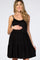 Smiling pregnant woman wearing a black sleeveless tiered maternity dress against a white background