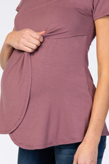 woman wearing a mauve maternity top with side ruching and a visible baby bump