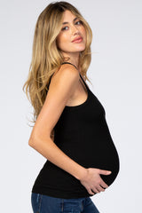 woman wearing a black fitted maternity tank top and holding her baby bump
