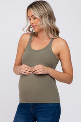 woman wearing a dark olive green maternity tank top and showcasing her baby bump