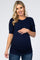 woman wearing a navy blue short sleeve maternity top and gently holding her baby bump