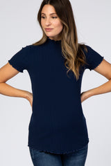 woman wearing a navy blue short sleeve ribbed mock neck top with lettuce edge trim and blue jeans