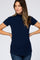 woman wearing a navy blue short sleeve ribbed mock neck top with lettuce edge trim and blue jeans