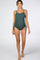 woman wearing a dark green ribbed maternity swimsuit with adjustable side ties and a visible baby bump