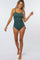 woman wearing a dark green ribbed one-piece swimsuit with adjustable side ties and spaghetti straps