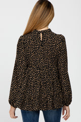 back view of woman wearing black and tan leopard print tiered long sleeve top with high neckline