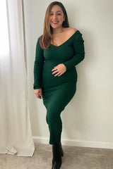 woman wearing a green ribbed off-the-shoulder long sleeve dress and black knee-high boots