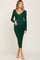 woman wearing a dark green ribbed maternity dress with a v-neck and long sleeves, holding her baby bump